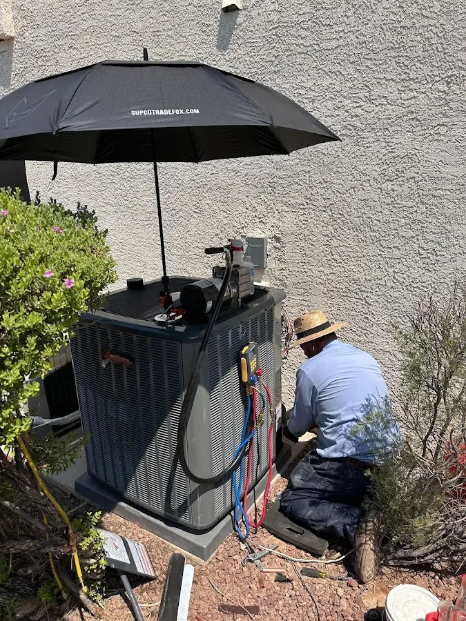 HVAC technician performing outdoor AC maintenance in Spirit Lake